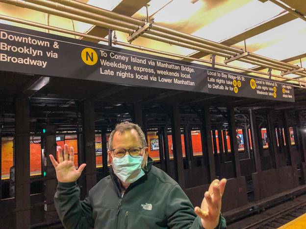 A picture containing text, train, person, station Description automatically generated